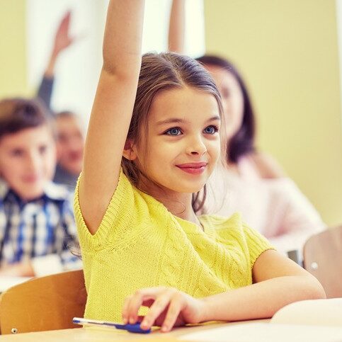 education, elementary school, learning and people concept - group of smiling school kids sitting in classroom