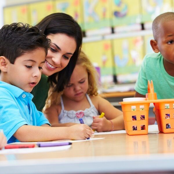 Group Of Elementary Age Children In Art Class With Teacher